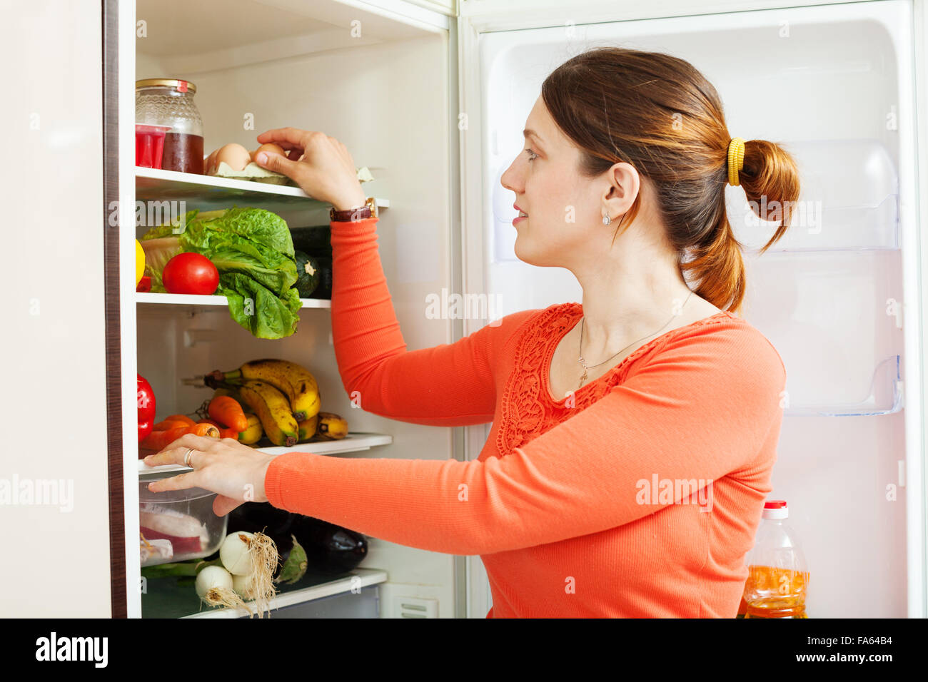 housewife near refrigerator  at home kitchen Stock Photo