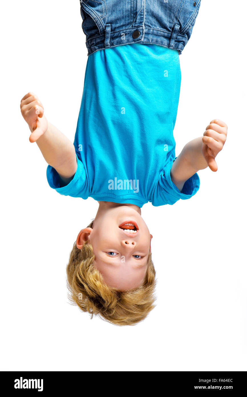 Handsome little boy hanging upside down Stock Photo Alamy
