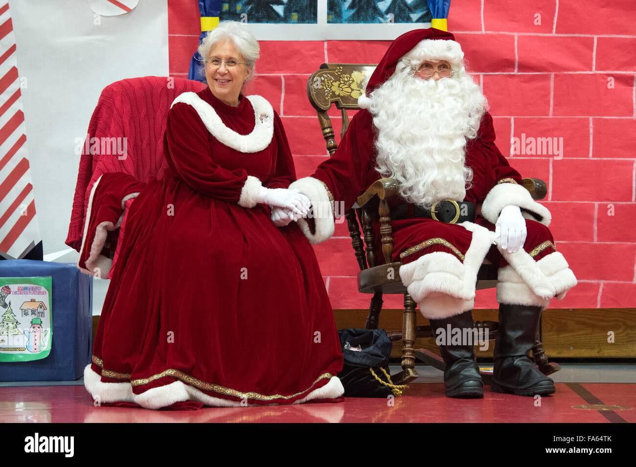 Santa Claus and Mrs Claus greet Native Alaskan children during a visit to remote villages as part of Operation Santa Claus December 5, 2015 in St. Mary's, Alaska. The program has been held for 59 years and brings Christmas cheer to underserved, remote villages across Alaska. Stock Photo