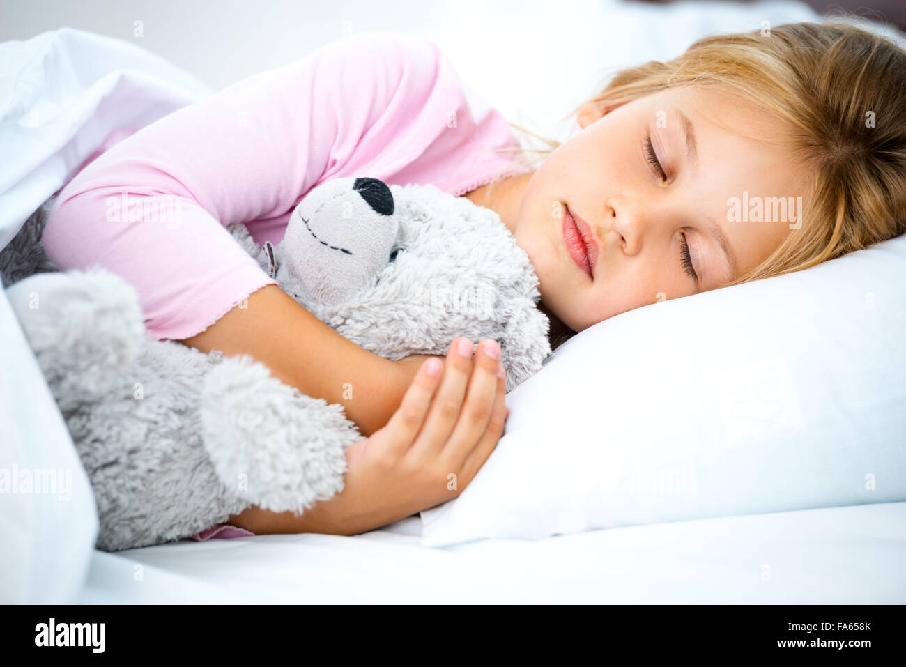 Little girl sleeping on white bed Stock Photo Alamy