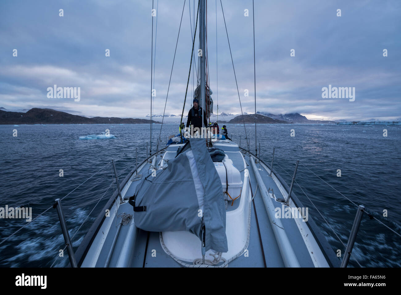 Sailboat sailing through sea ice near Tasiilaq, East Greenland Stock Photo
