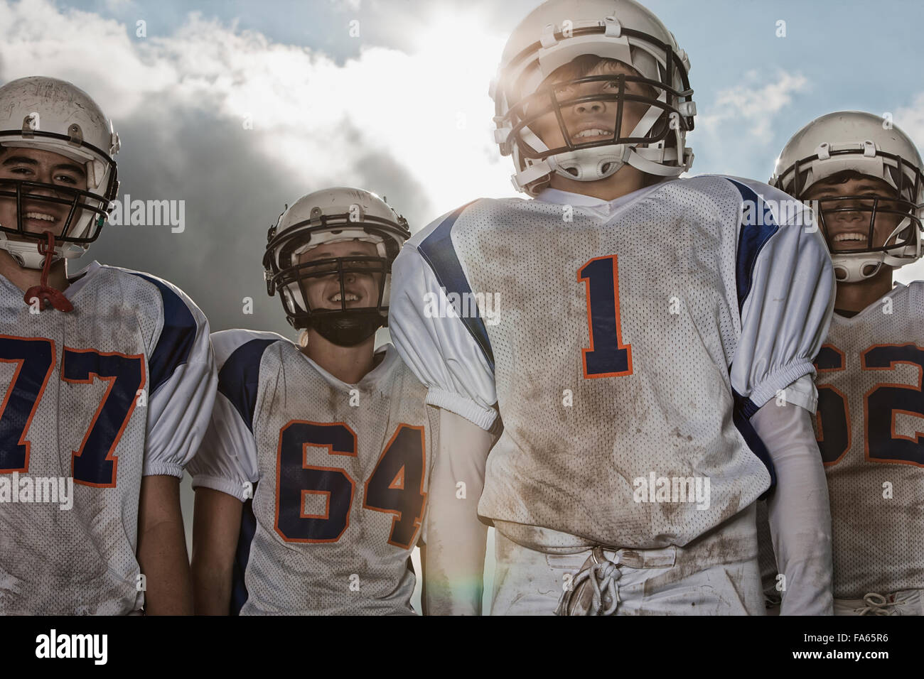A group of football players, members of a squad, young people in sports uniform and protective