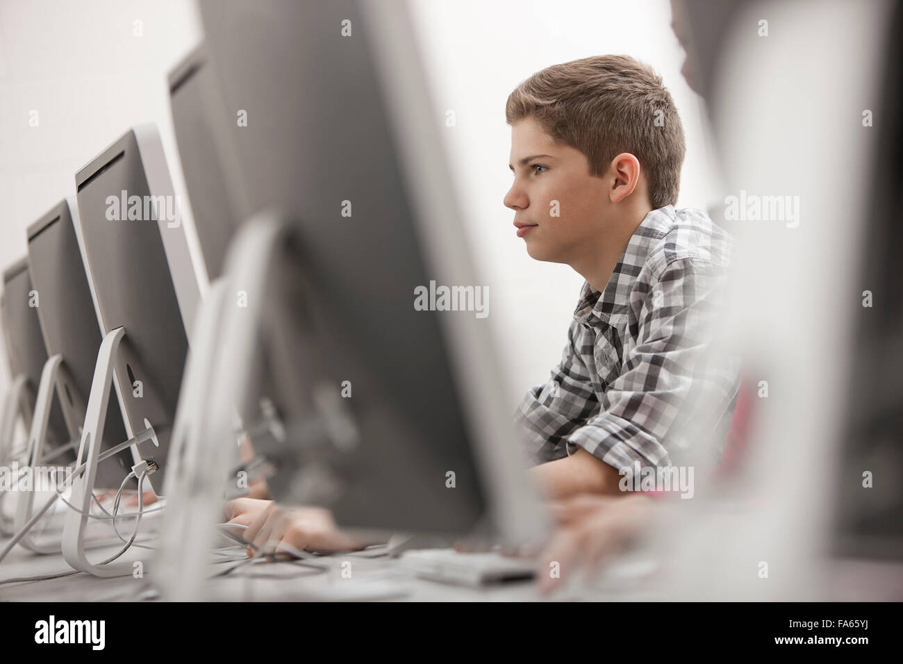 A school room computer laboratory or lab with rows of computer monitors ...