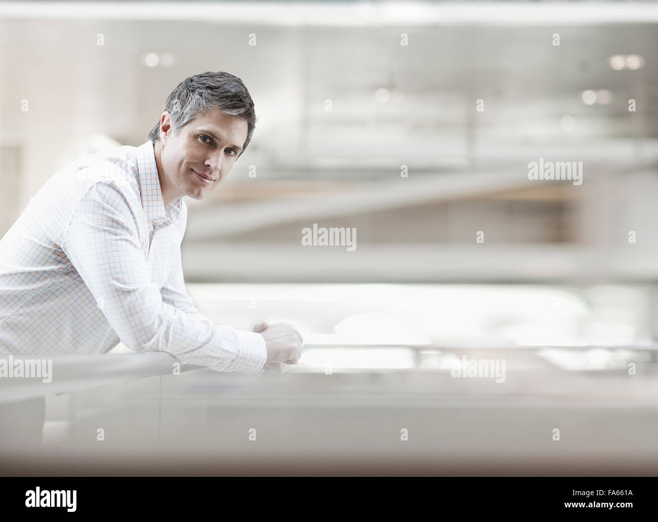 Airy Building A man in a white shirt with an open collar, in a large airy building ...