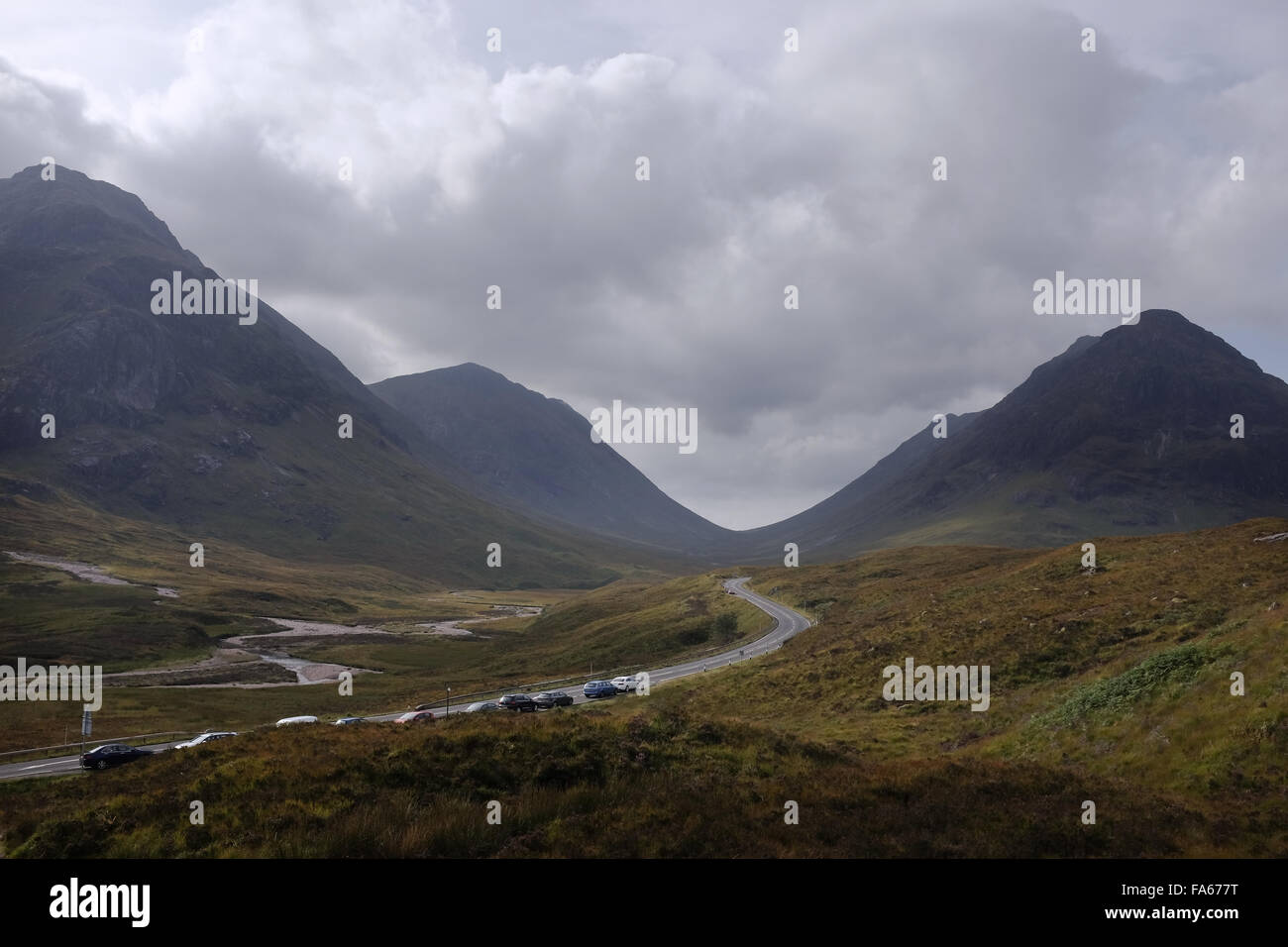 Row of Cars parked on road, Highlands, Scotland, United Kingdom Stock Photo