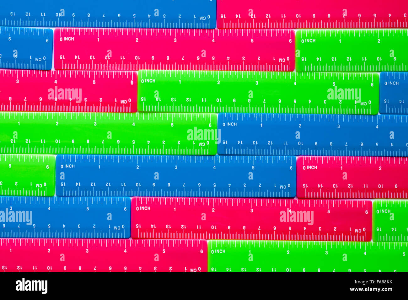 rows of colourful plastic blue pink and green rulers Stock Photo