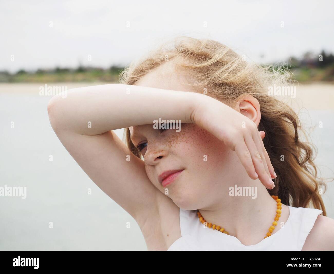 Portrait of a girl shielding her eyes Stock Photo