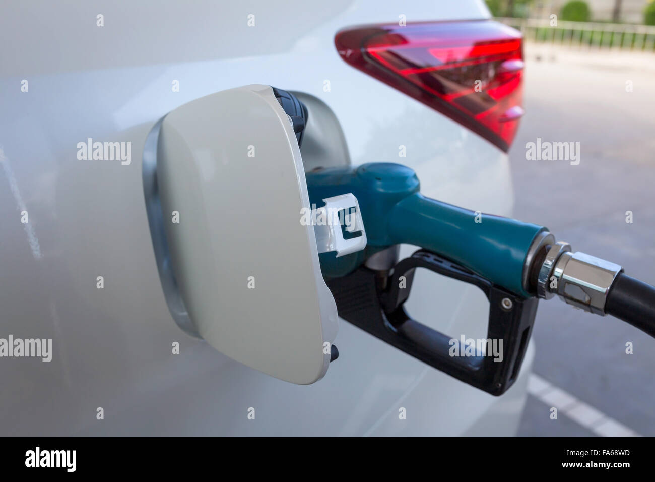 Close-up of gas nozzle in fuel tank of a car Stock Photo