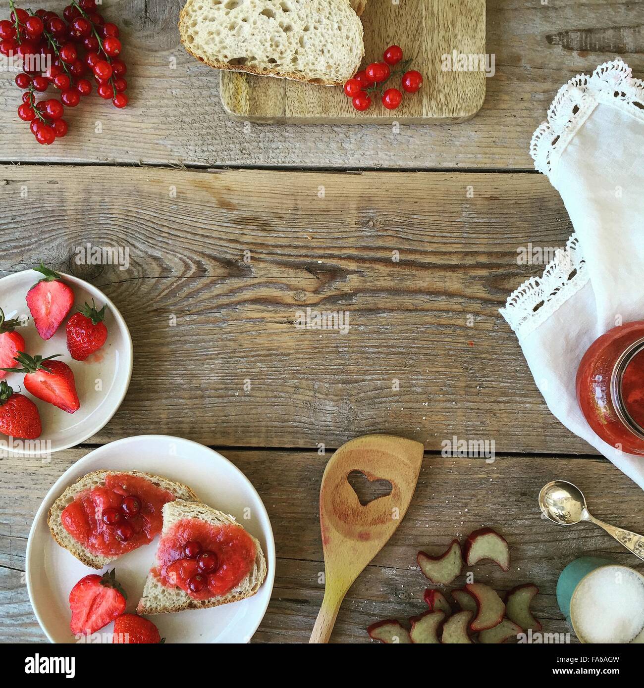 Strawberries, redcurrants, bread and jam Stock Photo
