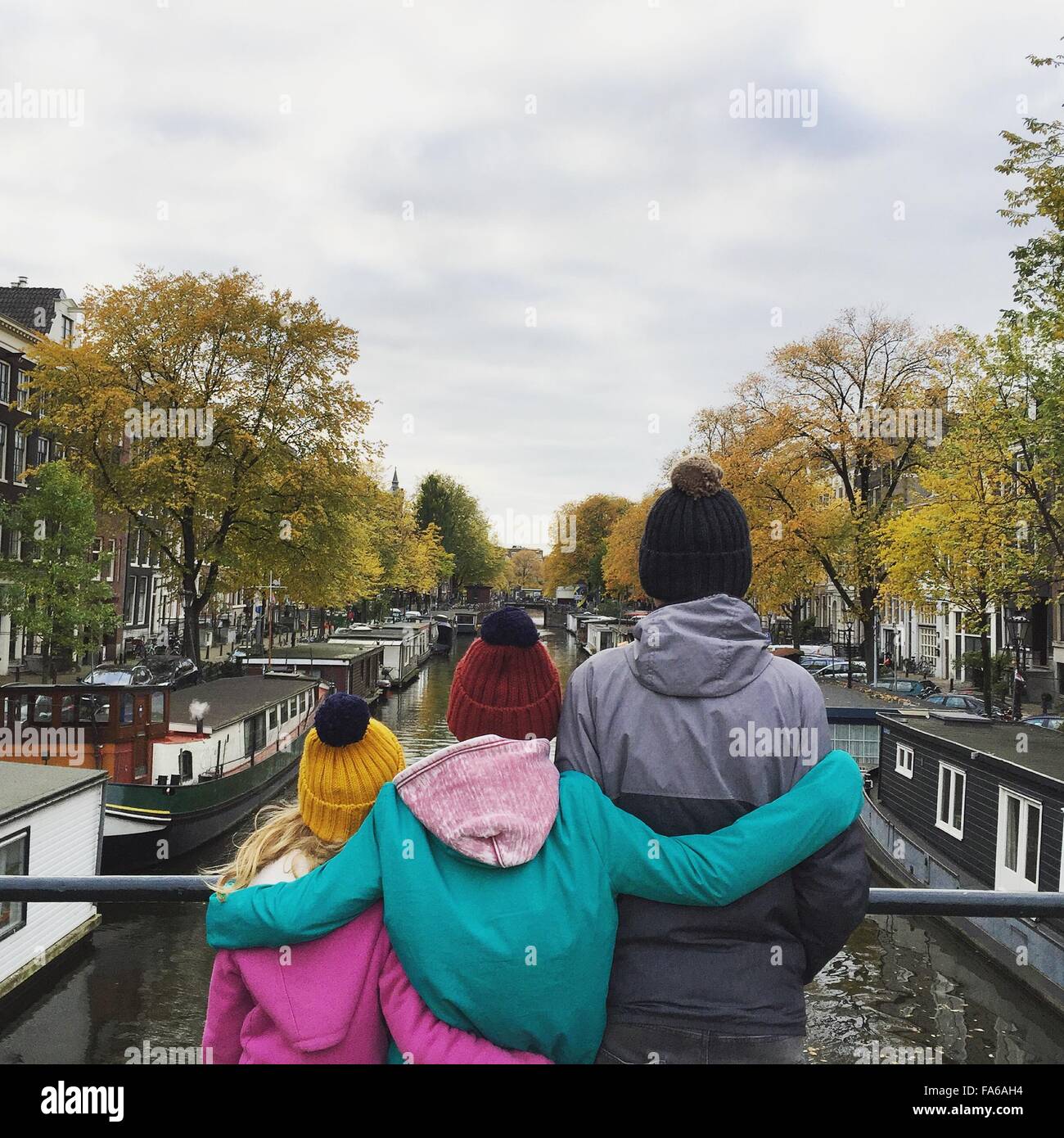 Rear view of two boys and a girl sightseeing in Amsterdam, Netherlands Stock Photo