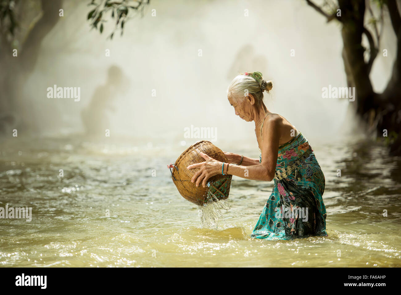 Senior woman fishing in streams Stock Photo
