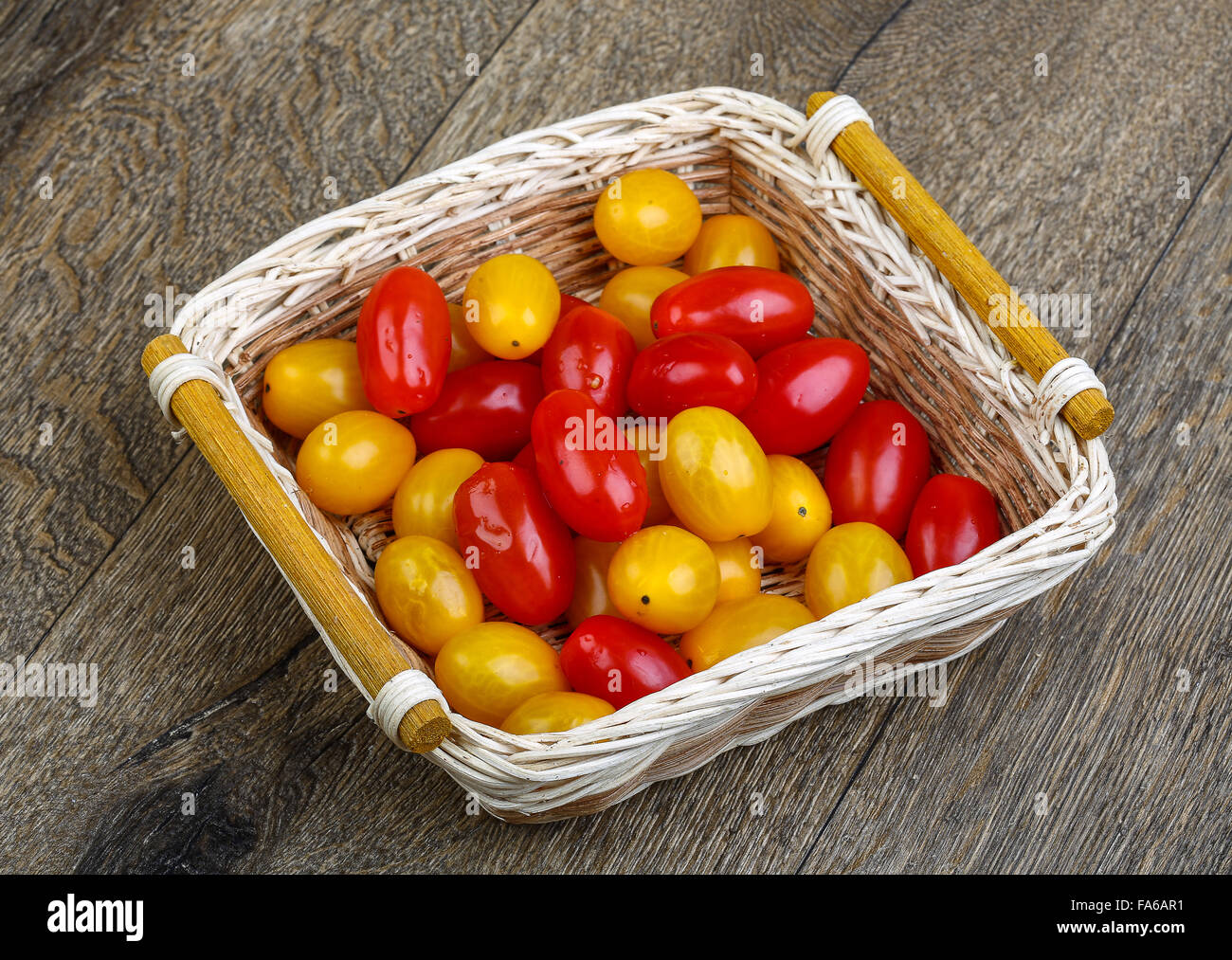 Yellow and red cherry tomatoes mix on the basket Stock Photo - Alamy