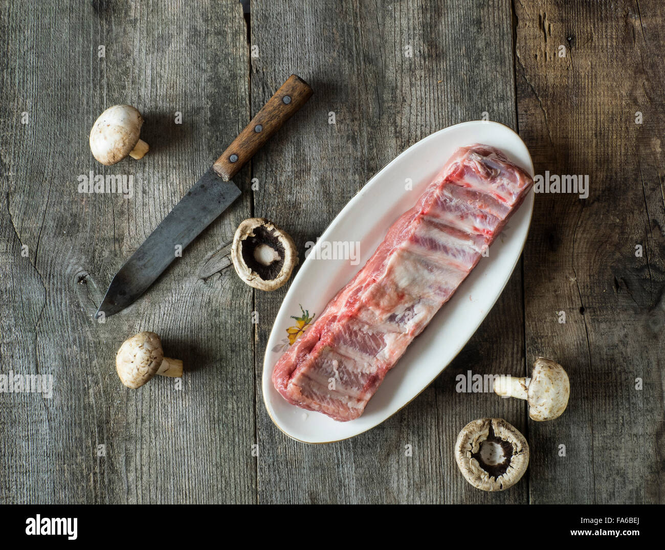 Raw pork ribs and fresh mushrooms Stock Photo
