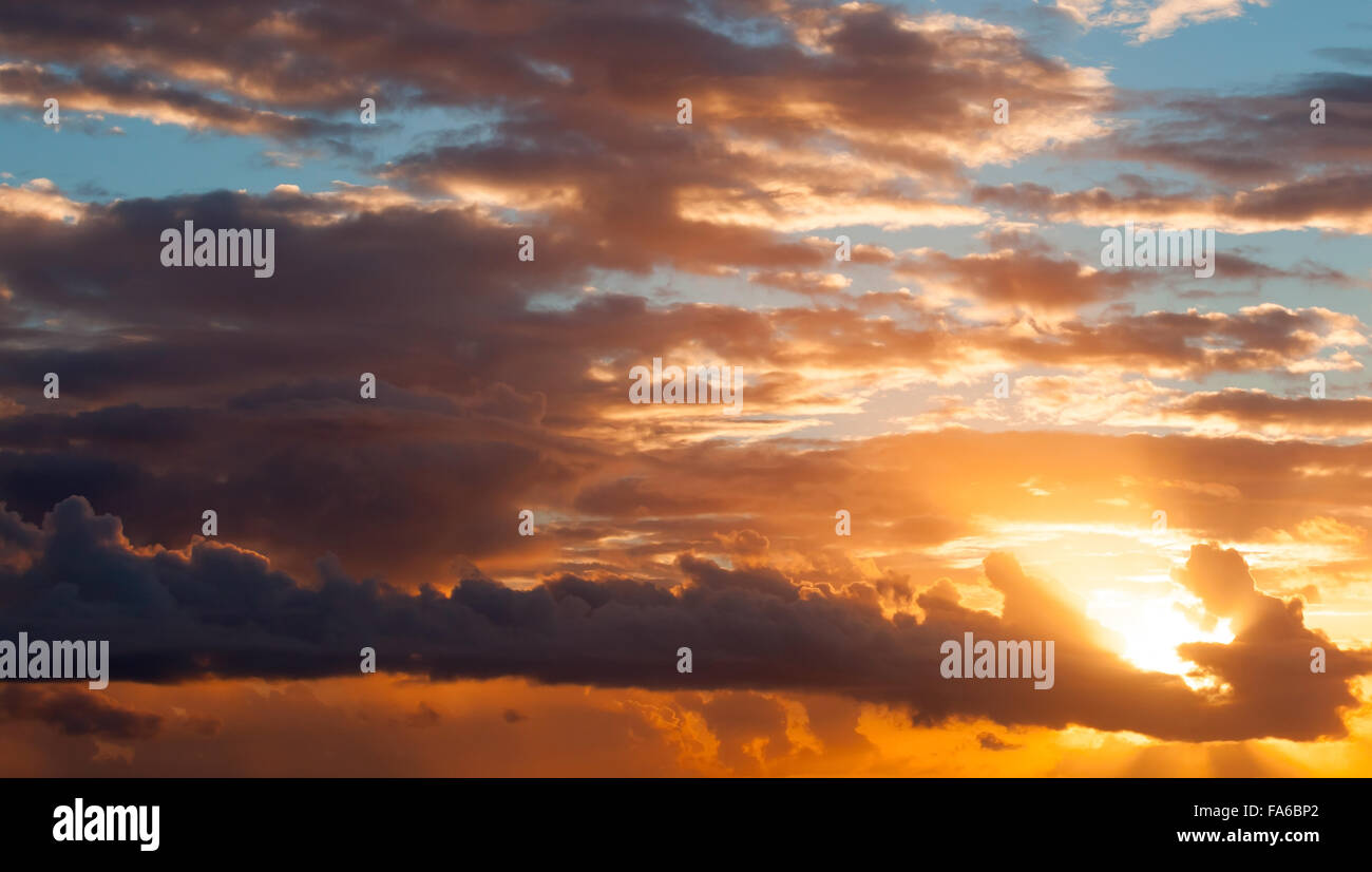 Colorful sunrise sky with red clouds and shining sun Stock Photo