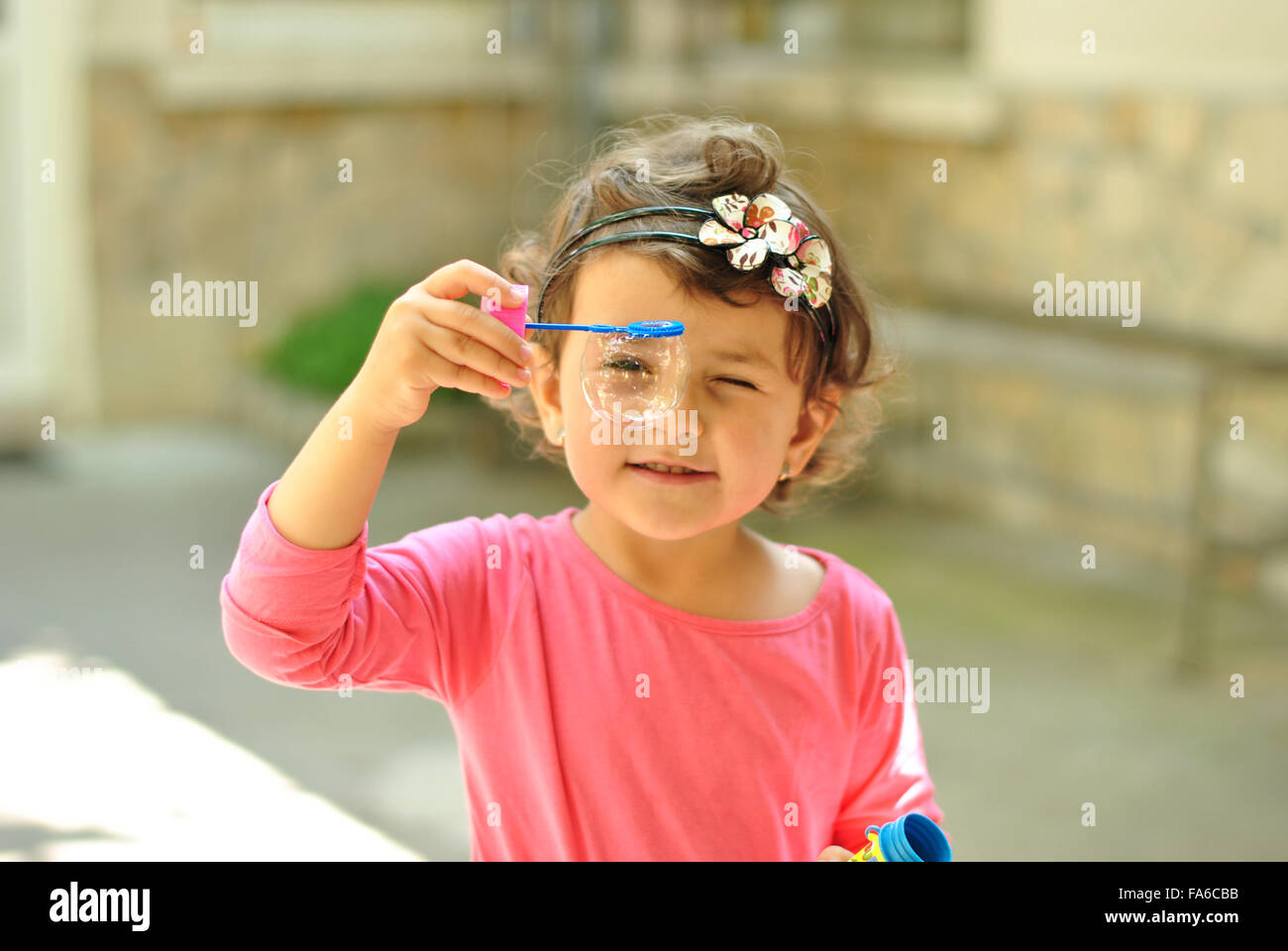 Girl holding a soap bubble wand Stock Photo