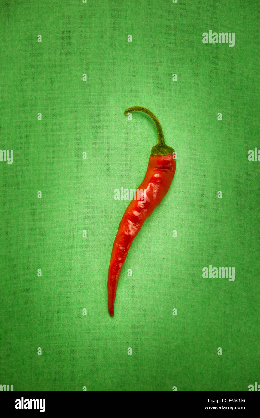 Red chili pepper on a green background Stock Photo