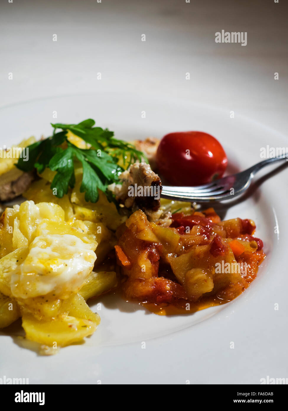 Plate of meat stew with potatoes and cheese Stock Photo