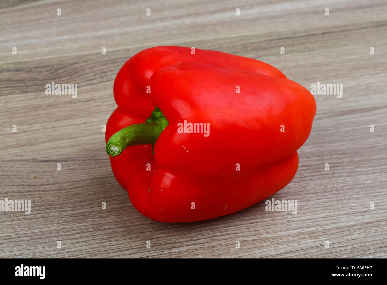 Red bell pepper on the wood background Stock Photo - Alamy