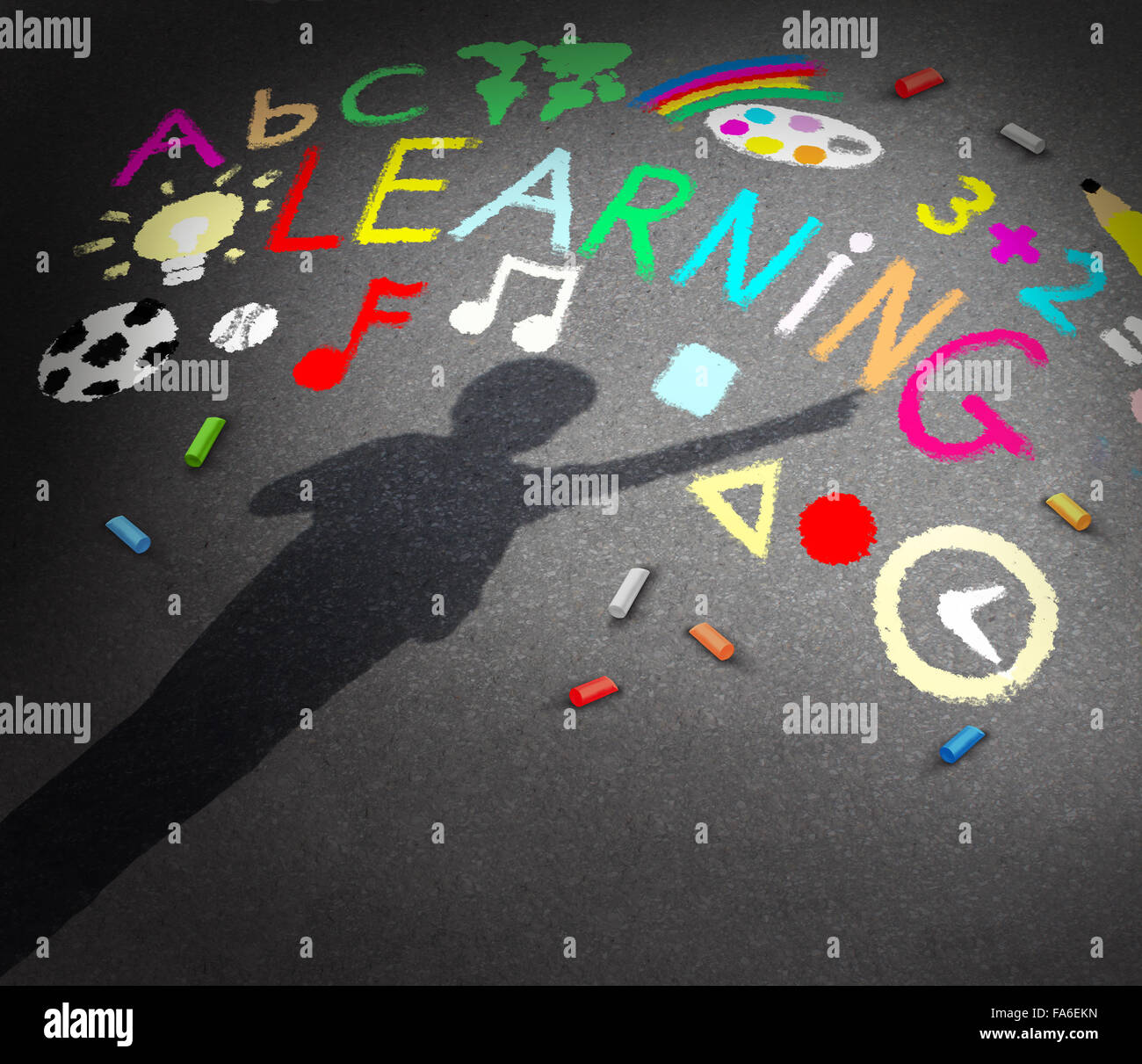 Child learning concept as the shadow of a young student on a schoolyard pavememt with chalk drawings of music math reading and art symbols as a metaphor for childhood creativity and the potential to learn and discover. Stock Photo
