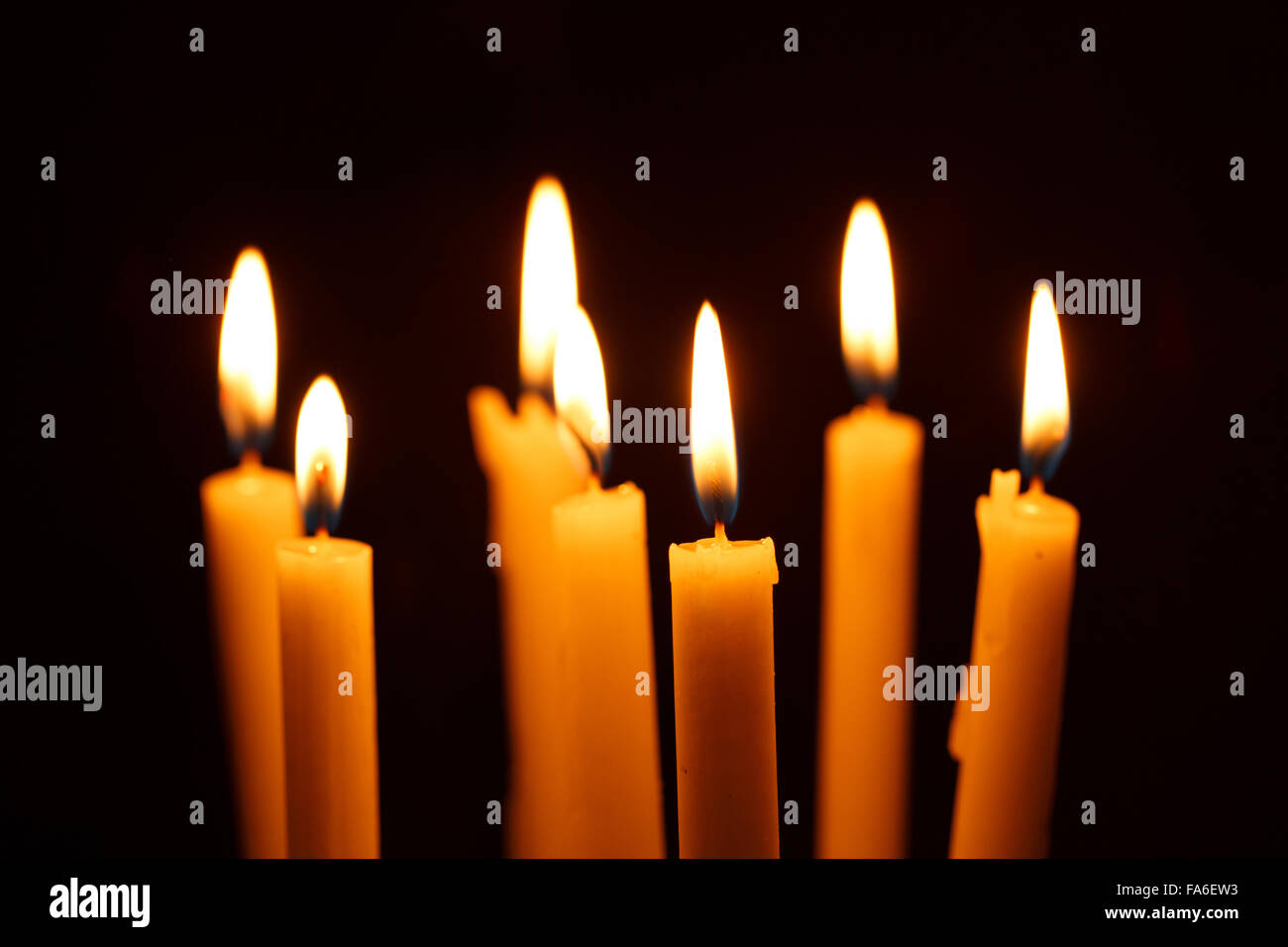 Many burning candles on black background Stock Photo - Alamy