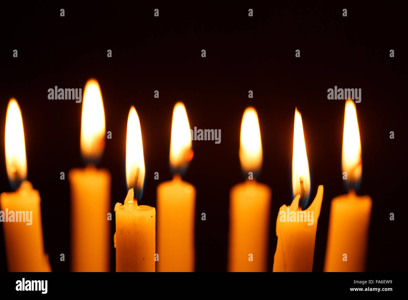 Many burning candles on black background Stock Photo - Alamy