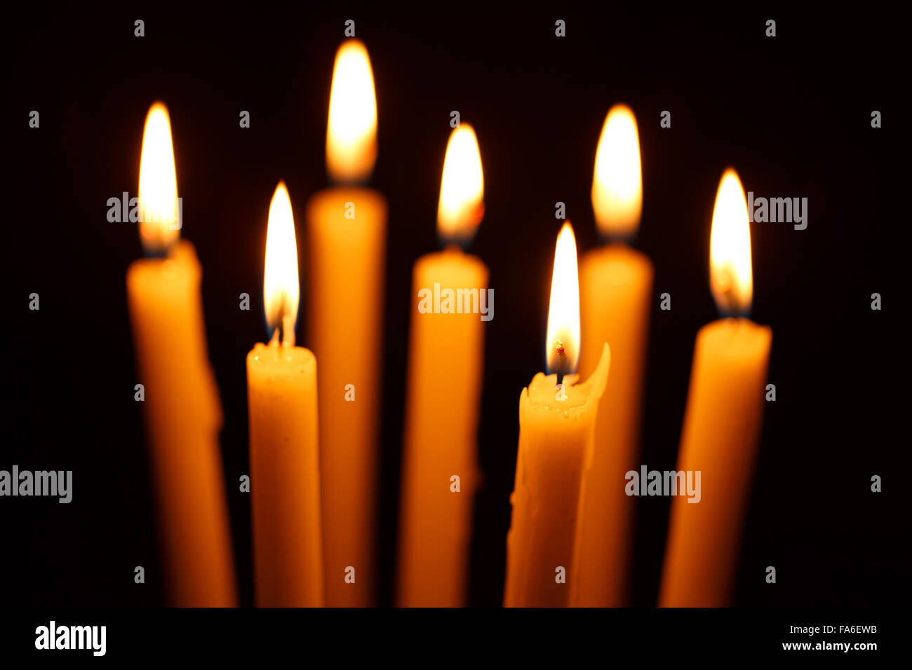 Many burning candles on black background Stock Photo - Alamy