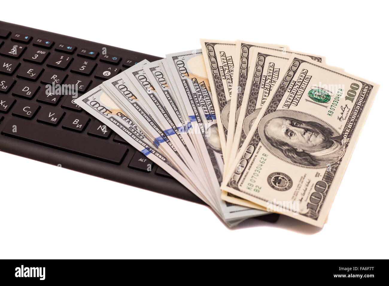 Stack of one hundred dollar bills on keyboard Stock Photo - Alamy