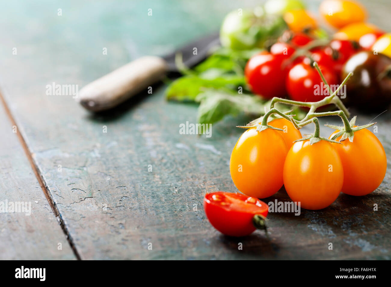 various of colorful tomatoes on wooden background Stock Photo - Alamy