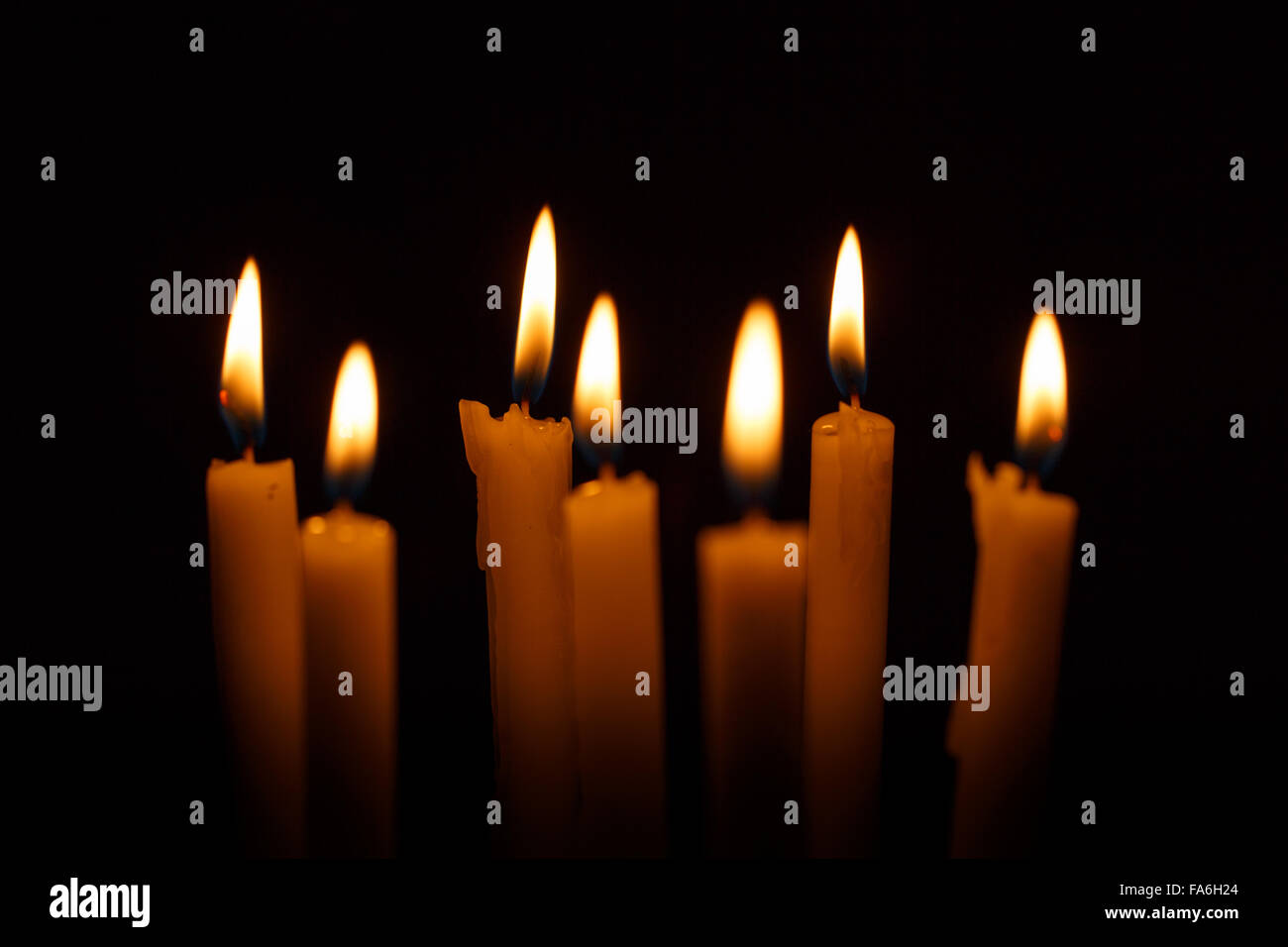Many burning candles on black background Stock Photo - Alamy