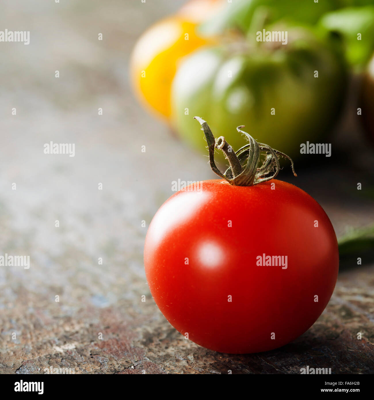 various of colorful tomatoes on wooden background Stock Photo - Alamy