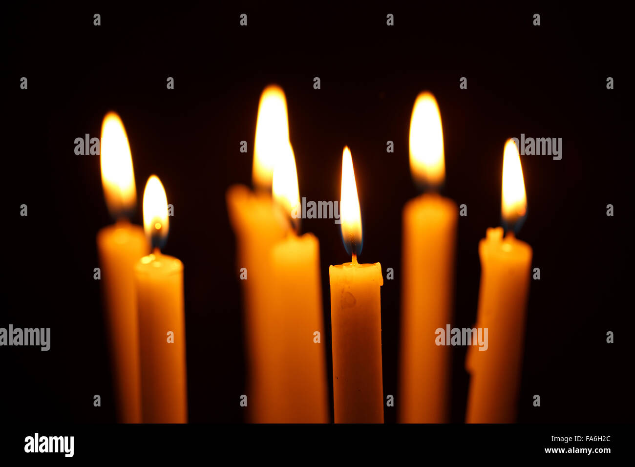 Many burning candles on black background Stock Photo - Alamy
