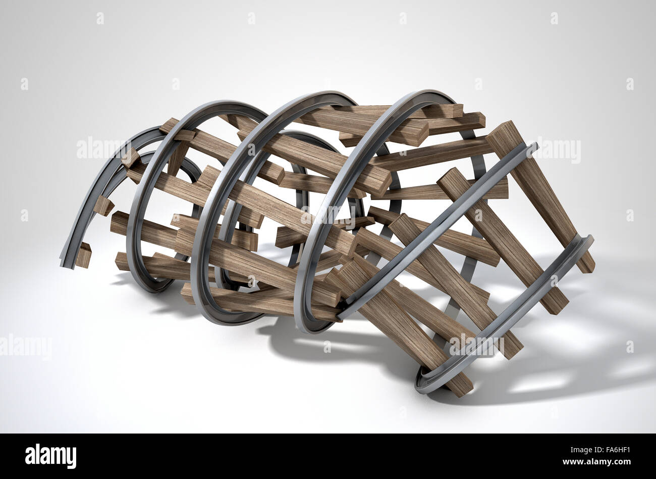 A concept showing a short piece of rail way track peeled into a spiral shape on an isolated white studio background Stock Photo