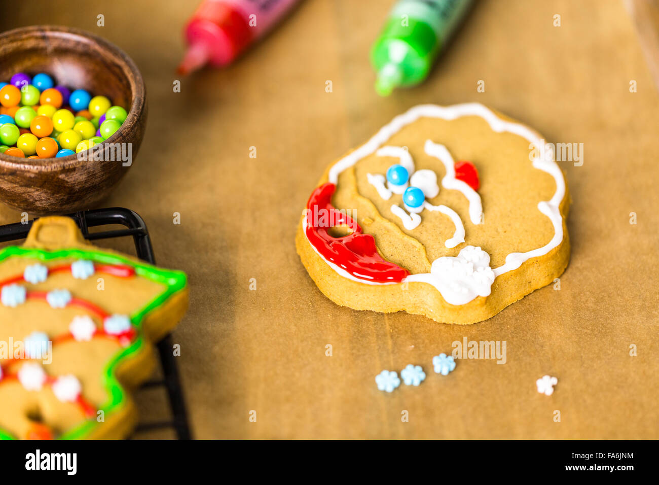 Decorating gingerbread cookies with royal icing and colorful candies