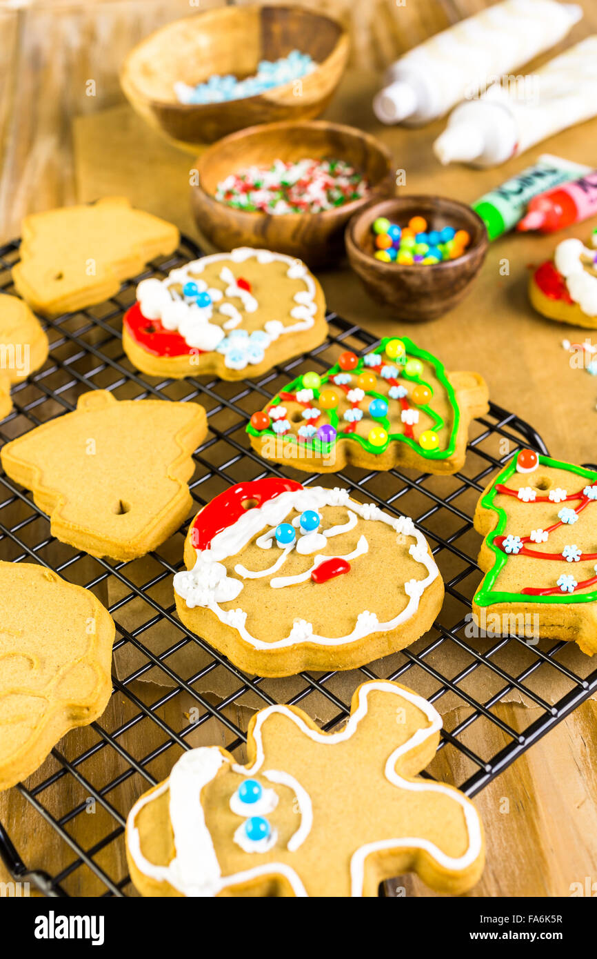 Decorating gingerbread cookies with royal icing and colorful candies