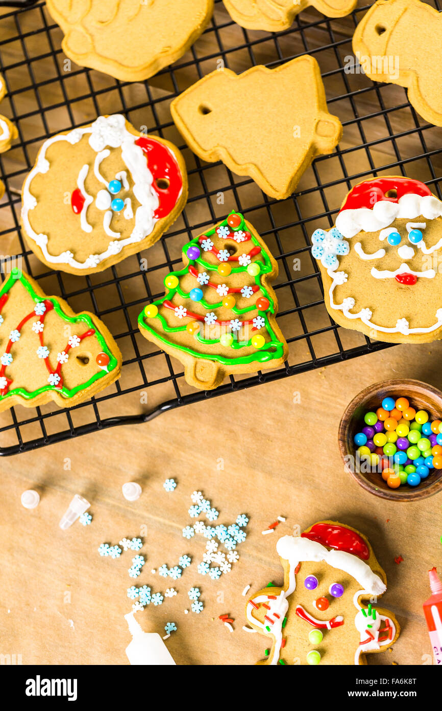 Decorating gingerbread cookies with royal icing and colorful candies