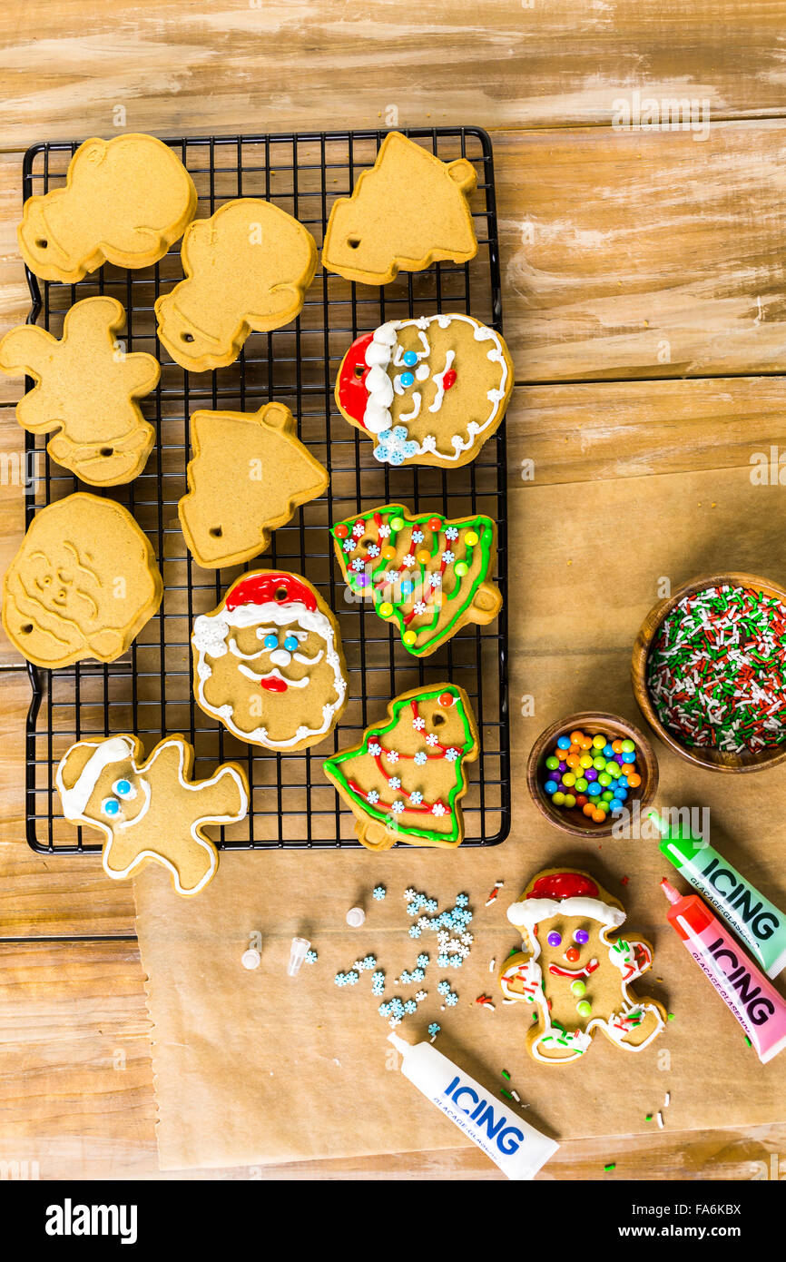 Decorating gingerbread cookies with royal icing and colorful candies