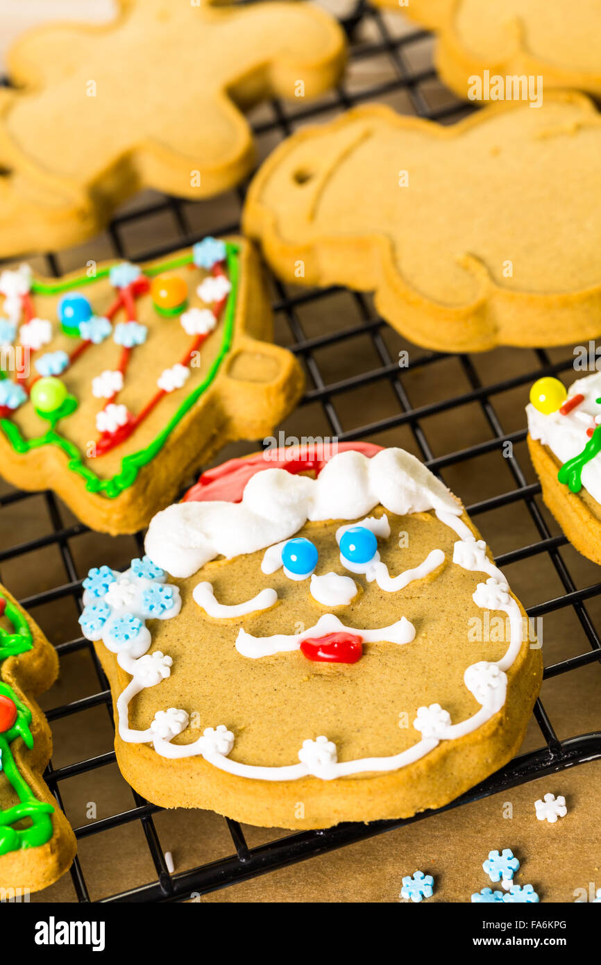 Decorating gingerbread cookies with royal icing and colorful candies