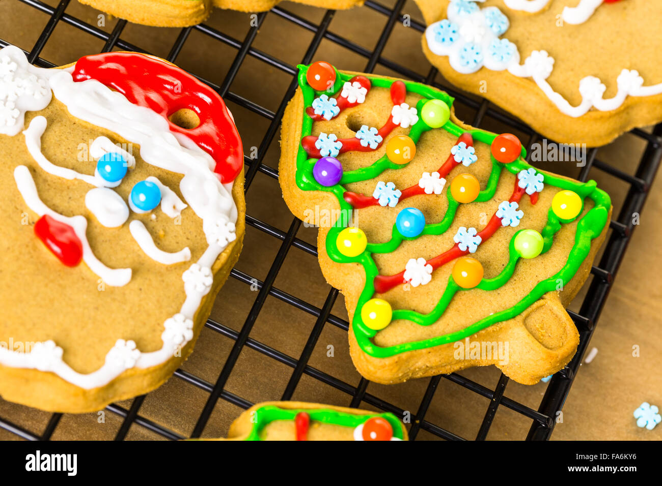 Decorating gingerbread cookies with royal icing and colorful candies