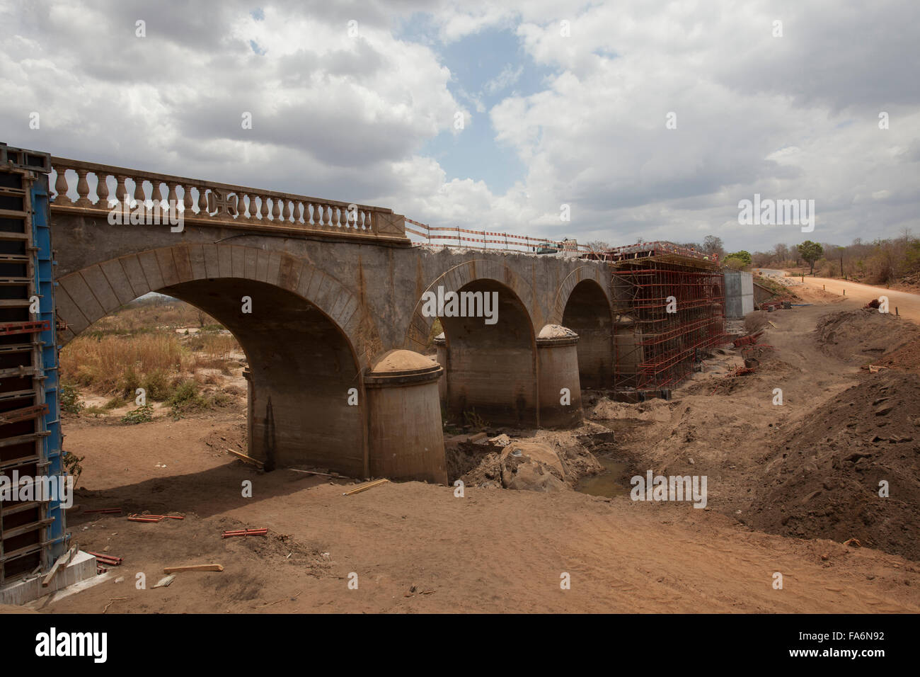 Construction workers rehabilitate an aging bridge along the Namialo to Rio Lurio Road in Northern Mozambique, SE Africa. Stock Photo