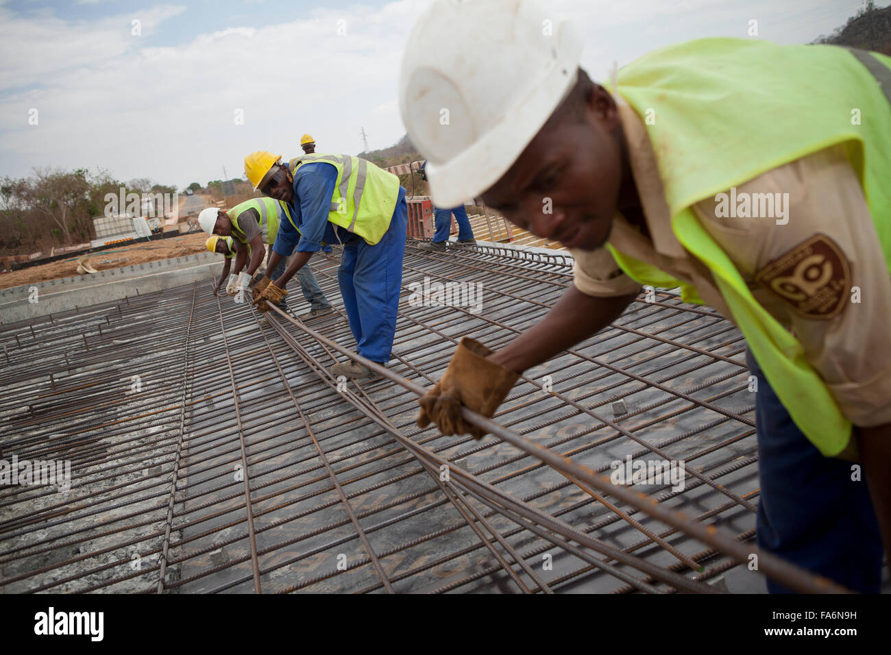 Construction workers rehabilitate an aging bridge along the Namialo to Rio Lurio Road in Northern Mozambique, SE Africa. Stock Photo
