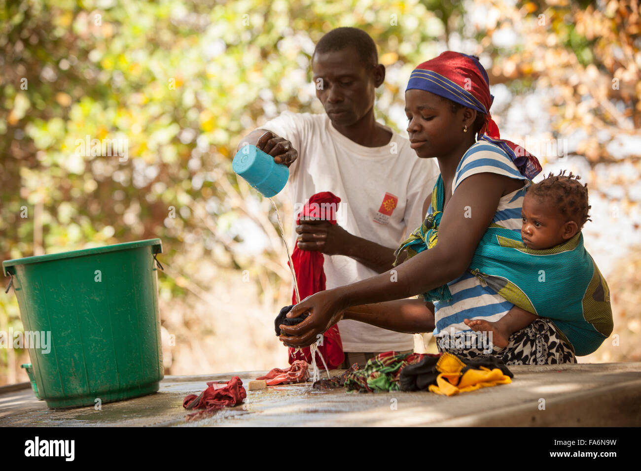 Community members wash their clothes with clean water in the village of Mecupes in Northern Mozambique. Stock Photo