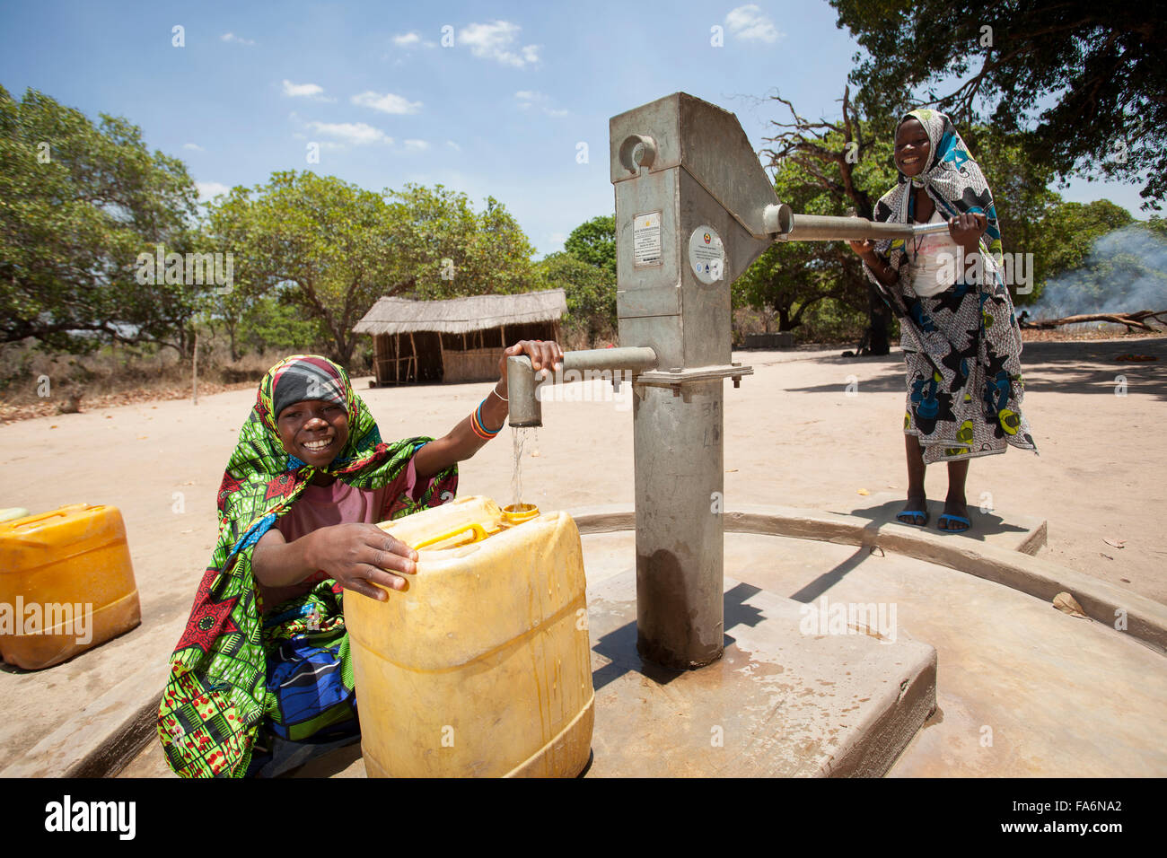 Children draw clean water from a borehole in Mecupes village, Northern Mozambique. Stock Photo
