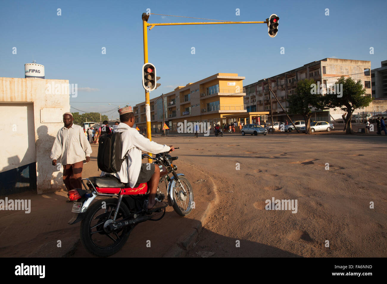 A pothole-ridden road in Nampula, Mozambique. Stock Photo