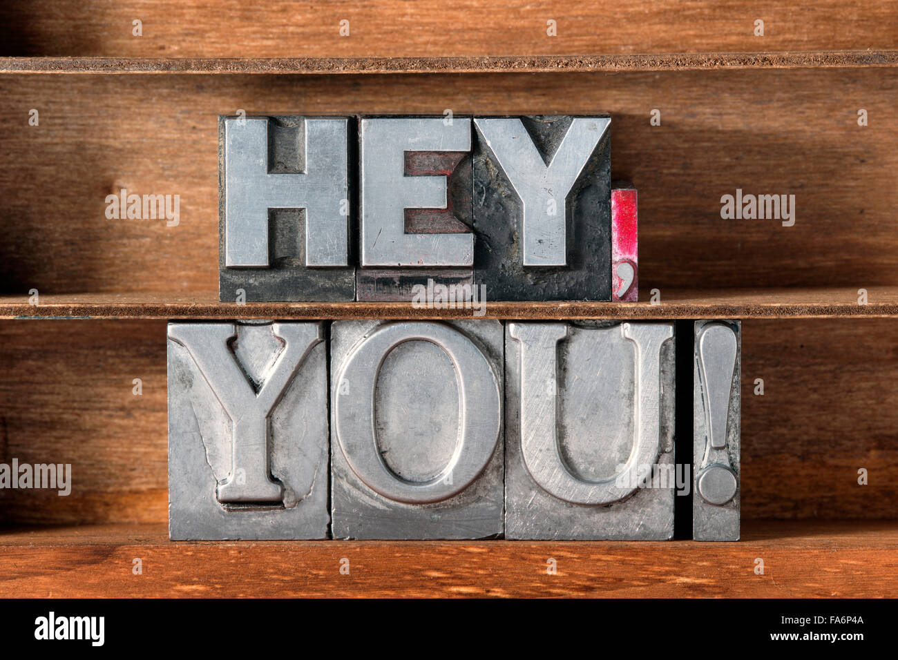 hey, you exclamation made from metallic letterpress type on wooden tray Stock Photo