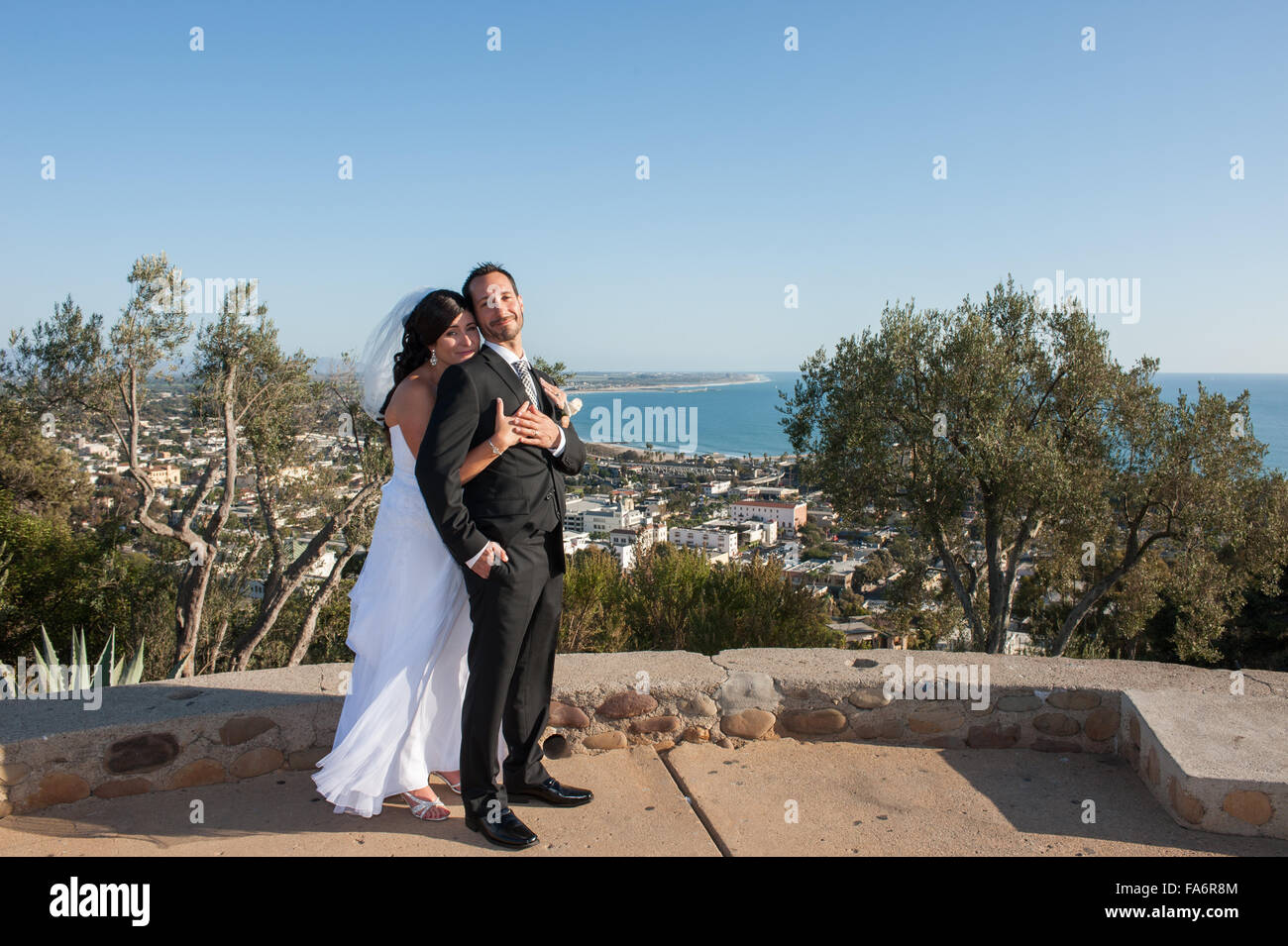 Wife giving husband a squeeze from behind Stock Photo