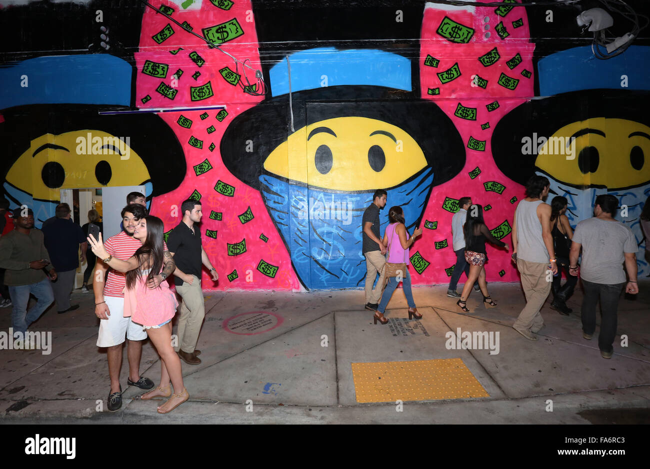 People tour art galleries in the Wynwood Arts District during Art Basel Miami.  (Photo by Sean Drakes/Alamy) Stock Photo