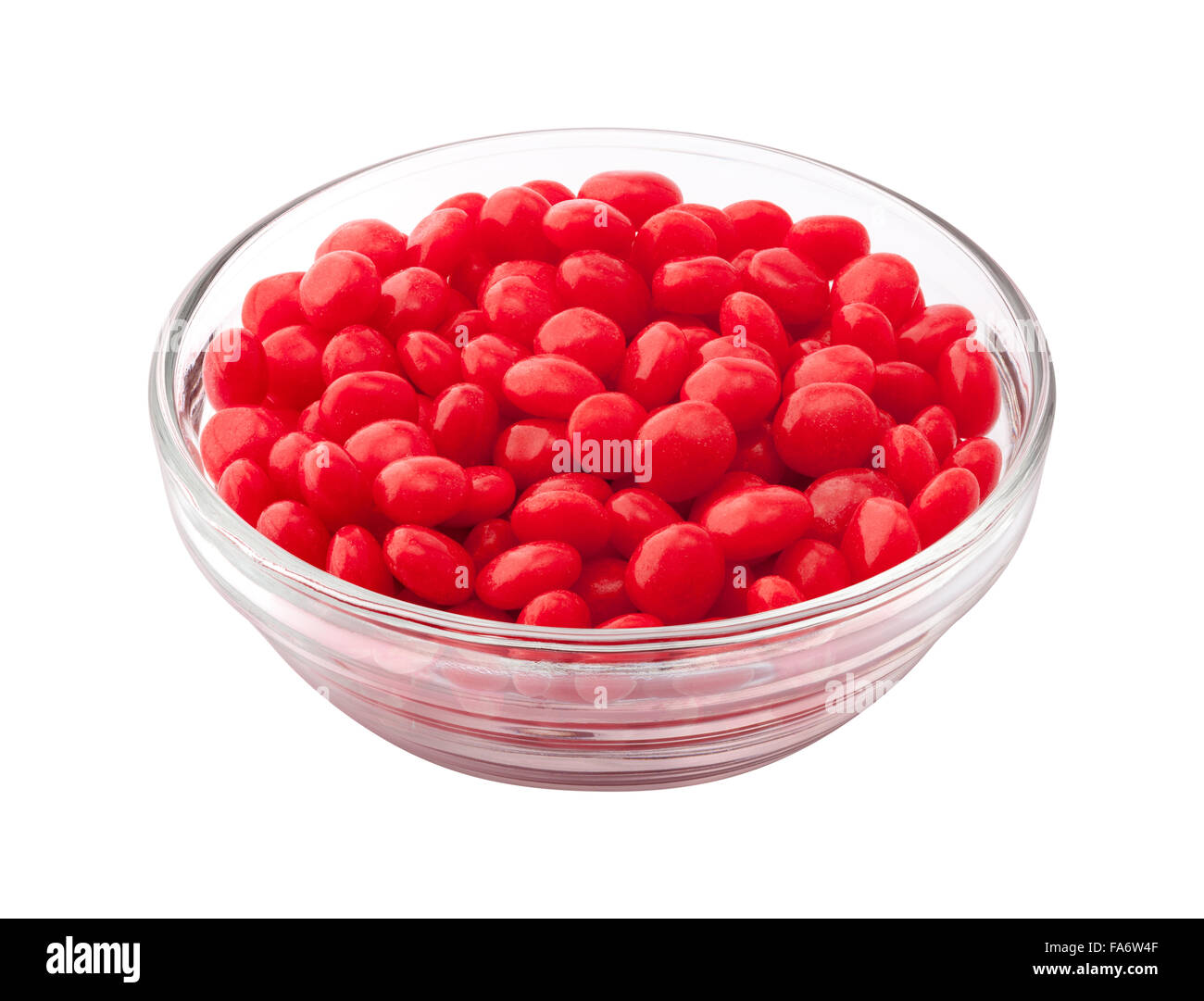Cinnamon Candy in a Glass Bowl. Commonly used as a spicy topping at Christmas and Valentines Day. The image is a cut out, isolat Stock Photo