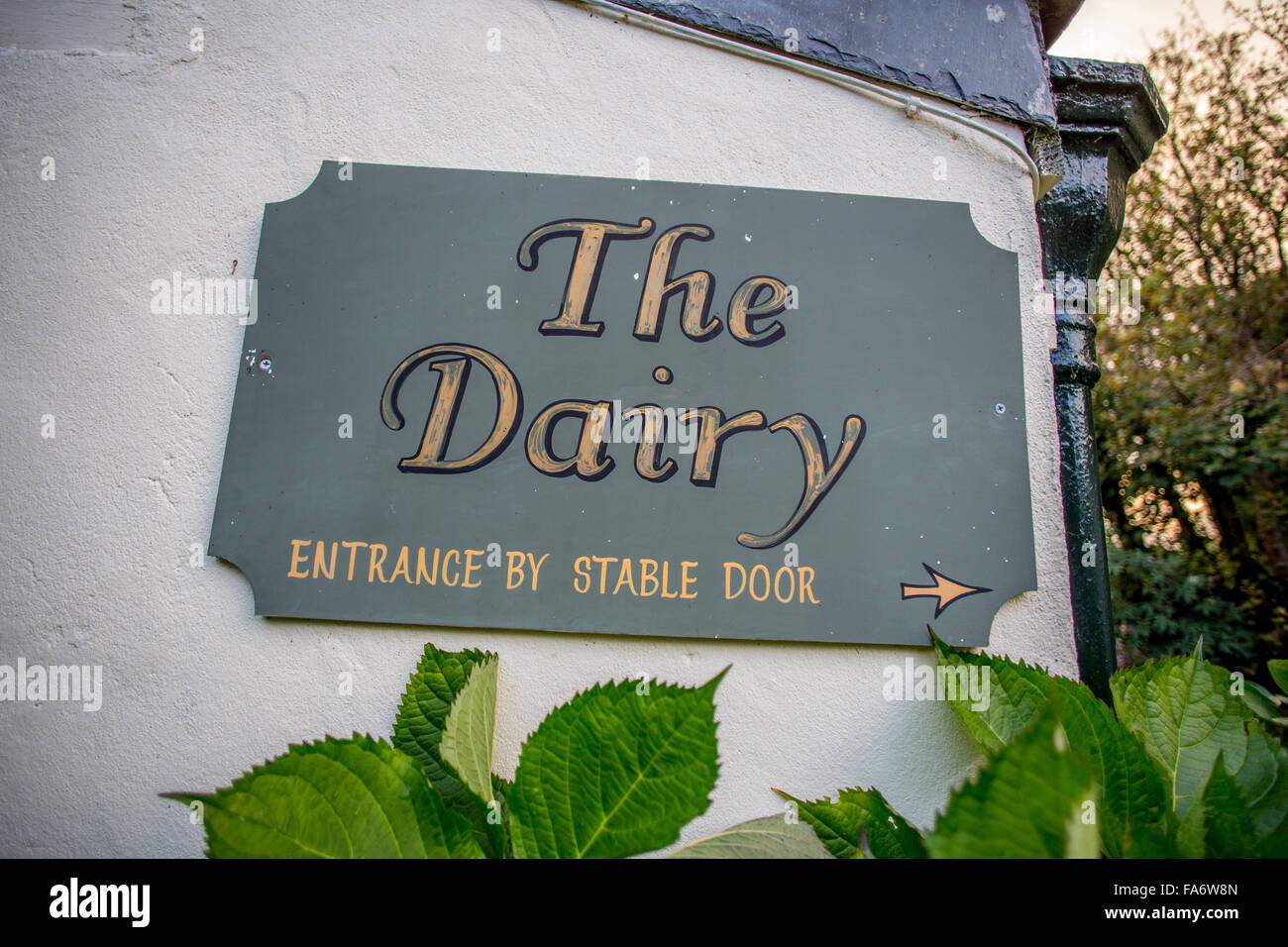The Dairy. Sign saying 'The Dairy' in yellow letters on blue grey slate Stock Photo