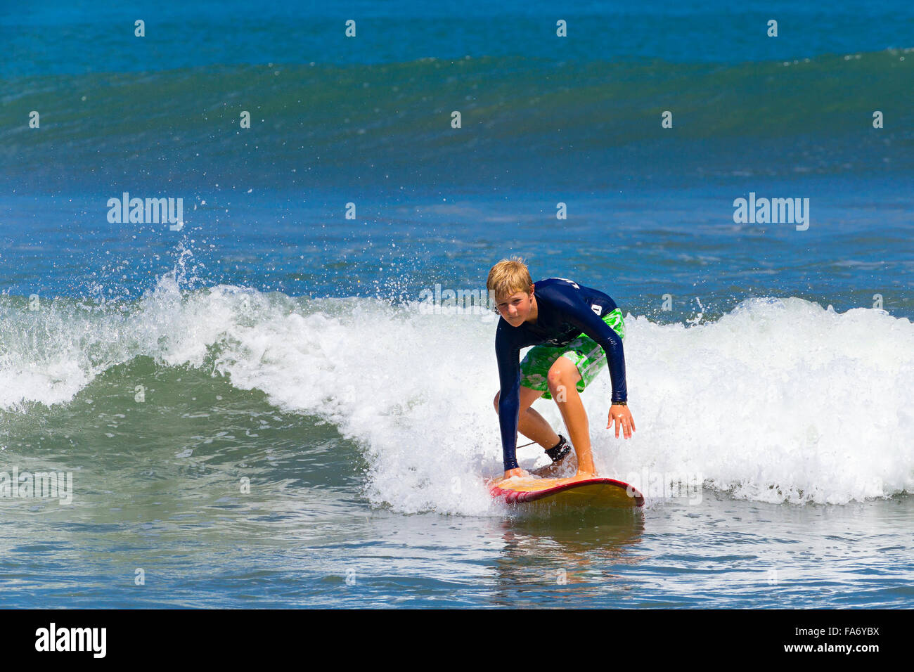 A boy, 12 years, surfing, Kuta, Legian, beach and surfing paradise, Bali, Indonesia Stock Photo