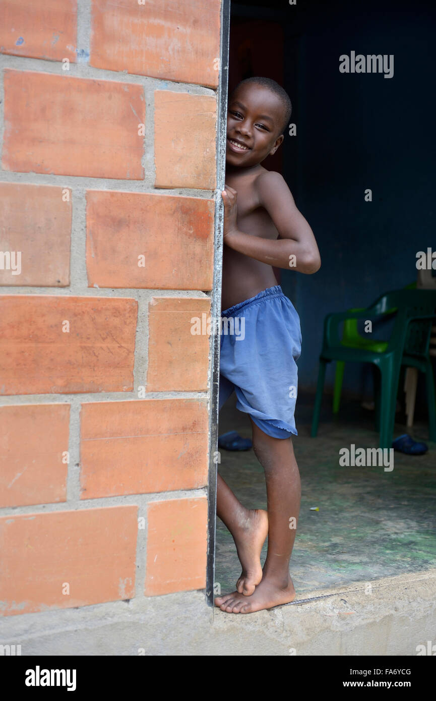 Boy in a door, afro-columbian village of El Salto on the River Rio Andagueda, Chocó Department, Colombia Stock Photo